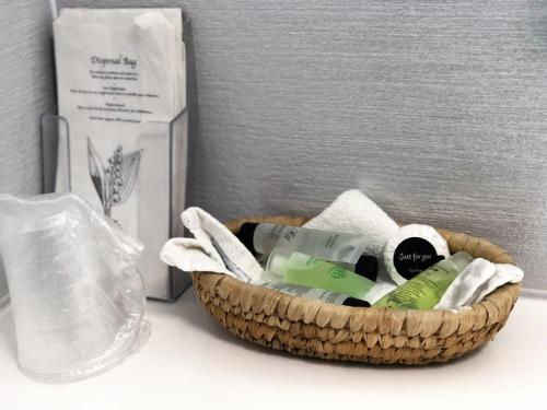 a basket filled with soap and a bottle on a counter at Ilfracombe House Hotel - near Cliffs Pavilion in Southend-on-Sea