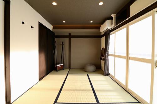 a japanese room with a large window at One's Villa Sapporo in Sapporo