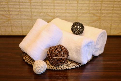 a plate with towels and balls on a table at One's Villa Sapporo in Sapporo