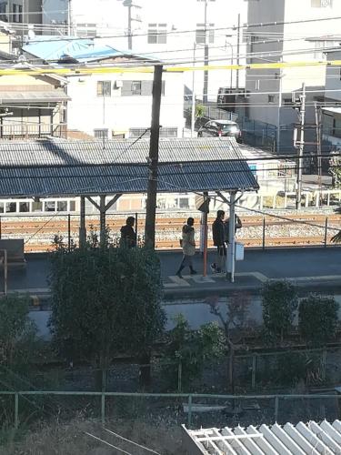 a group of people standing at a train station at NEBULA K in Kumagaya