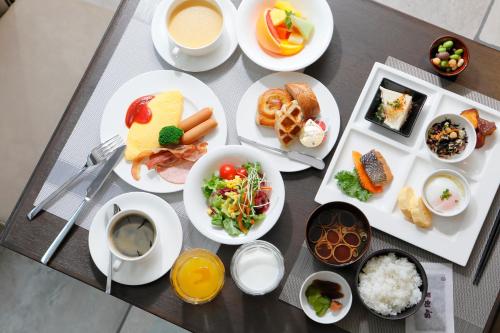 a table topped with plates of food and cups of coffee at Nagoya Tokyu Hotel in Nagoya