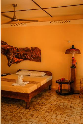 a bedroom with a bed with a cat sitting on it at Deep Forest Garden Hotel in Puerto Princesa City