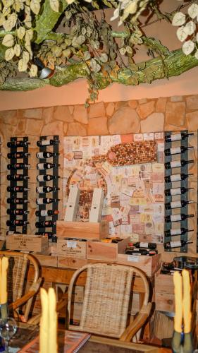 a room with a table with chairs and wine racks at Deep Forest Garden Hotel in Puerto Princesa City