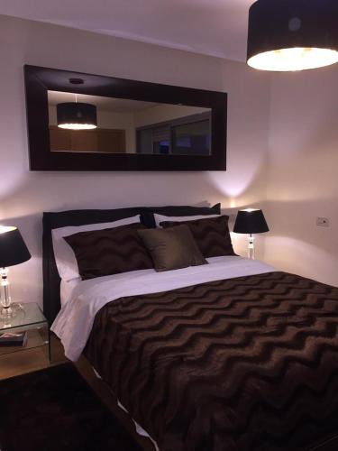 a bedroom with a large bed and a mirror at luxury apartment in Marina Casablanca in Casablanca