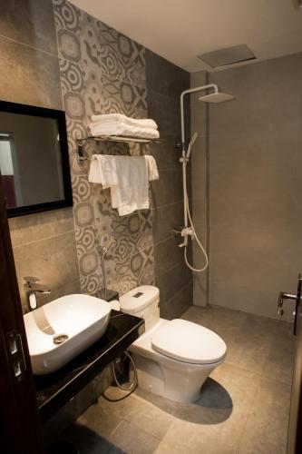 a bathroom with a toilet and a sink at Max Boutique Hotel in Cao Bằng