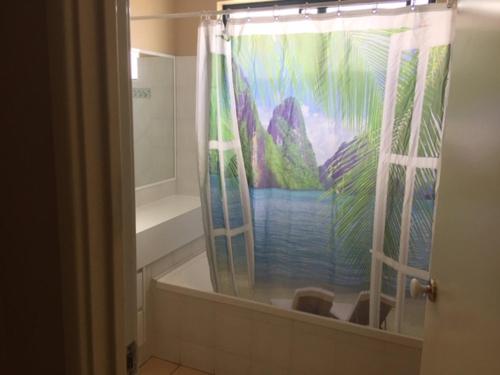 a bathroom with a shower curtain with a mural of a mountain at Beautiful Retreat by the Beach - 1 Lecaille Court in Dunsborough