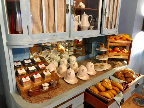 a display case with tea pots and cups and bread at VILLA OXA - Boutique Design Hotel in Maria Alm am Steinernen Meer