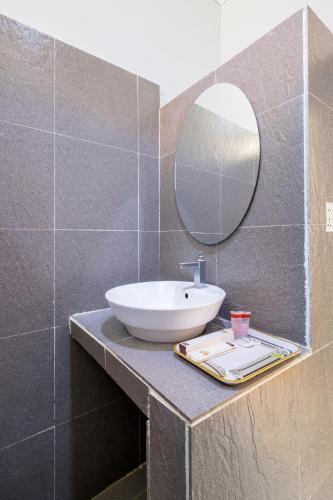 a bathroom with a sink and a mirror on a counter at Kep Bungalows in Kep