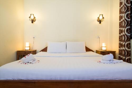 a bedroom with a bed with two towels on it at Kep Bungalows in Kep