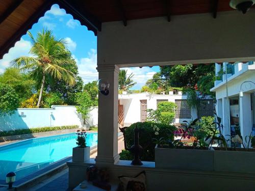 a view of a swimming pool from a house at Kaya Residence Kandy in Kandy