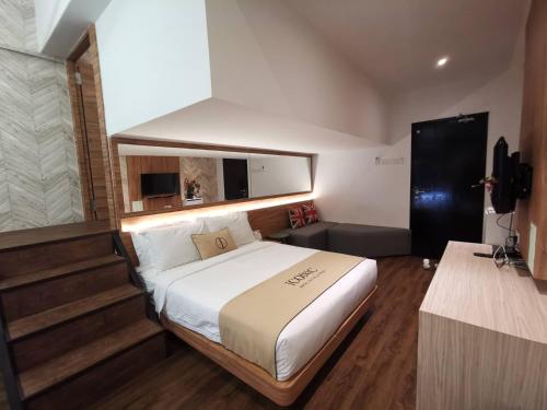 A bed or beds in a room at Iconic Suites & Pods Hotel
