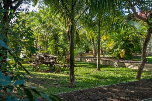 a park with a bench and palm trees at Kep Bungalows in Kep