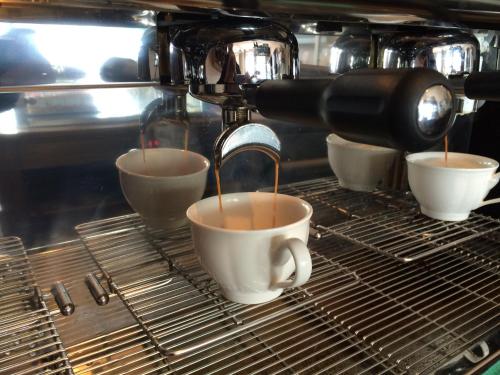 a coffee machine is making cups of coffee at Strand-Hotel Seenelke in Wilhelmshaven