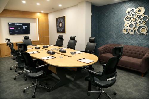 a conference room with a large table and chairs at Meshal Hotel in Manama