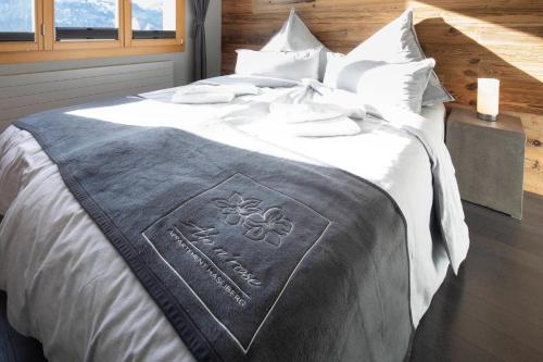 a bed with an olympics blanket on it at Alp n' rose in Hasliberg