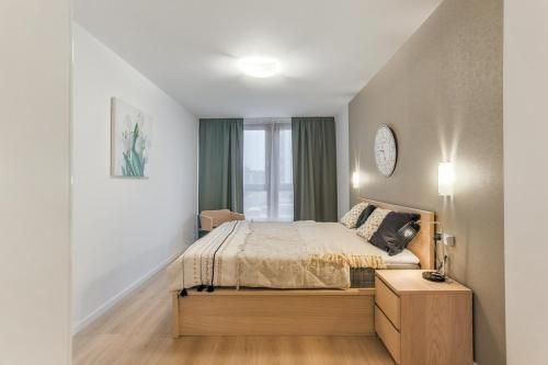 a bedroom with a bed and a window at ApartMate Spacious Apartment with balcony OldTown for 6 people in Gdańsk