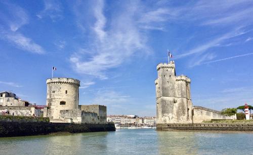 two towers on the side of a body of water at Boutique Hôtel d'Orbigny Chatelaillon - La Rochelle in Châtelaillon-Plage