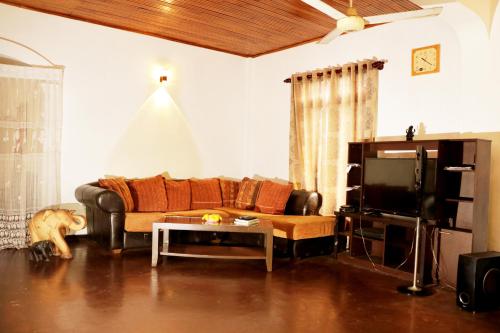 a living room with a couch and a table at Ariyadasa Guest House in Galle