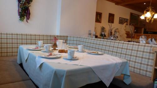 a table with a white table cloth on it at Gästehaus Alpenland in Tux