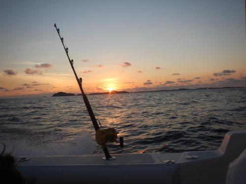 a fishing pole on the back of a boat in the ocean at Beached Bungalow Overlooking the Pacific Ocean in Boca Chica