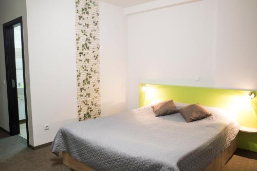 a bedroom with a bed with a white comforter at Vila William’s in Braşov