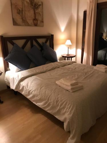 a bedroom with a large bed with two towels on it at Villa 38 in Casares