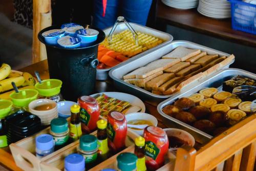 a table with various food and drinks and snacks at Baan Tubkaek Hotel in Tab Kaek Beach