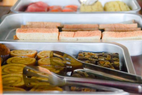 two trays of food with different types of food at Baan Tubkaek Hotel in Tab Kaek Beach