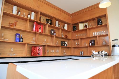 a kitchen with wooden shelves with wine glasses at Van Kim Long in Ấp Ðông Quì