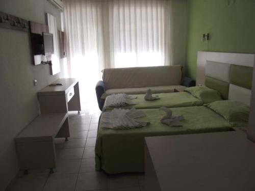 a living room with a bed and a couch at Derya Motel in Side