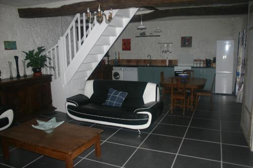 a living room with a couch and a table at L'ancienne cave in Prinçay