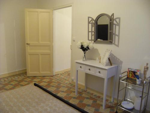 a room with a table and a mirror and a door at Chez'Artistes in Argelès-sur-Mer