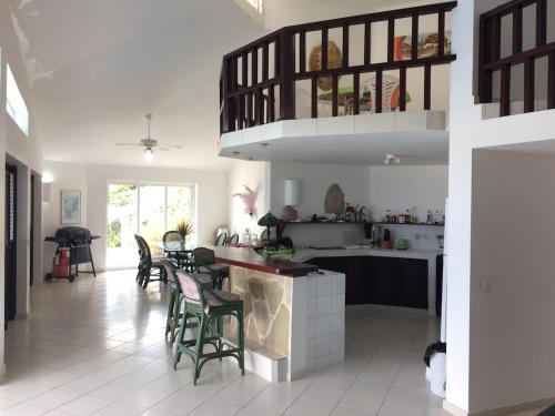 a kitchen with chairs and a counter in a room at Casa Caracol Los Farallones in Cabrera