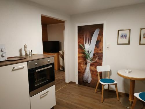 a kitchen with a counter and a table with chairs at Ferienwohnung Sailer in Fügen