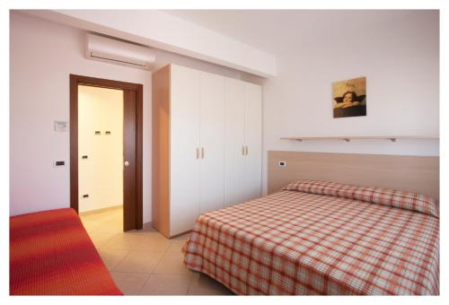 Ένα ή περισσότερα κρεβάτια σε δωμάτιο στο Casavacanze Internazionale