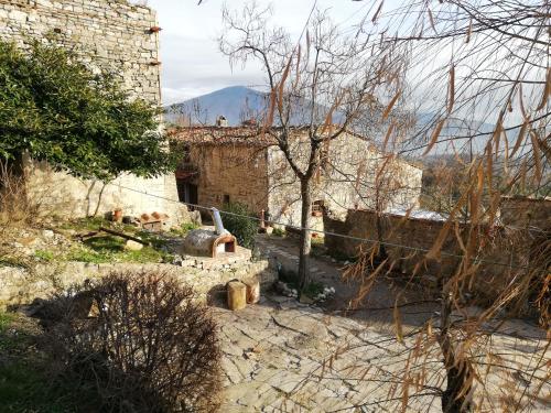an old stone building with a mountain in the background at Agriturismo CasaMatta Azienda Agricola in Calenzano