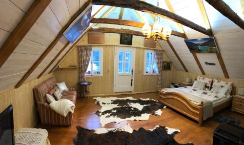 a attic room with a bed and a couch at Chalet anno 1794 in Rettenegg