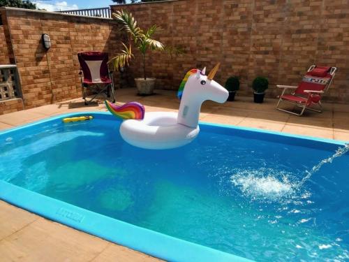 a unicorn inflatable toy in a swimming pool at Pousada Praias do Gostoso in São Miguel do Gostoso