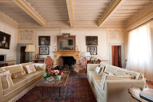 een woonkamer met banken en een open haard bij Villa di Cabbiavoli in Castelfiorentino