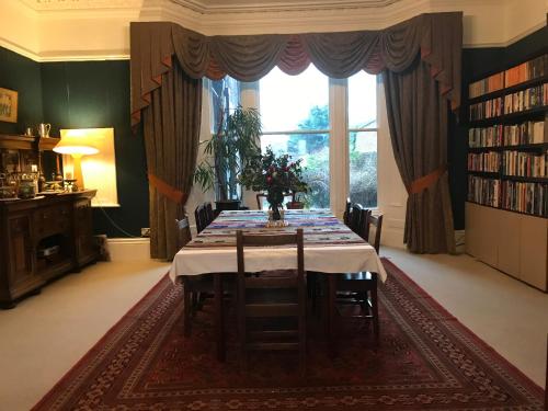 a dining room with a table and a large window at Aberley House in Liverpool