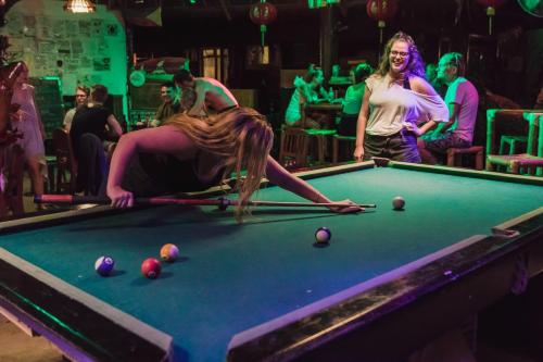 a woman playing pool in a pool table at Frendz Hostel Boracay in Boracay
