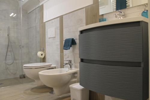 a bathroom with a white toilet and a sink at La Casetta di Anna in Capri