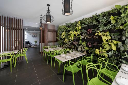 a restaurant with green plants on the wall at Foresta Hotel in Medellín