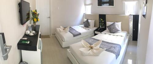 a room with two beds with flowers on them at Muine Sports Hotel in Mui Ne
