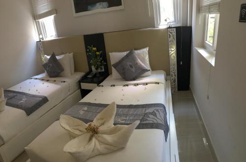 a room with two beds with flowers on them at Muine Sports Hotel in Mui Ne