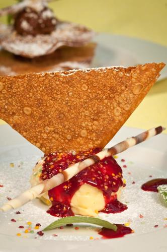 a plate of food with a piece of bread and fruit at Hotel Leon D'Oro in Orta San Giulio