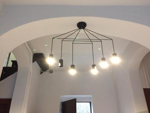 a chandelier hanging from a ceiling in a room at Studio Fibra Doppio in Rybnik