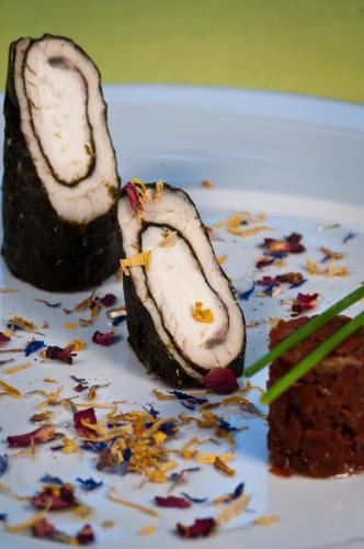 a piece of sushi on a plate with a piece of cake at Hotel Leon D'Oro in Orta San Giulio