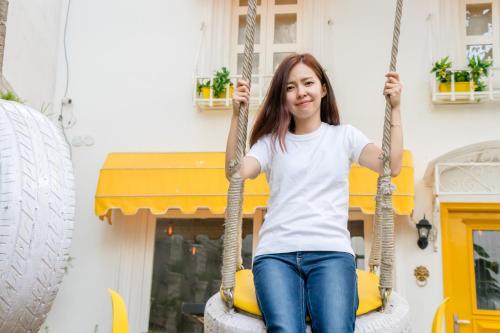 a woman sitting on a tire swing at Stay Banaras - A Boutique Hotel in Varanasi