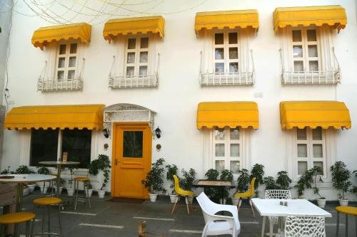 a building with yellow doors and tables and chairs at Stay Banaras - A Boutique Hotel in Varanasi